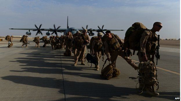 Soldiers lining up to board a military aircraft