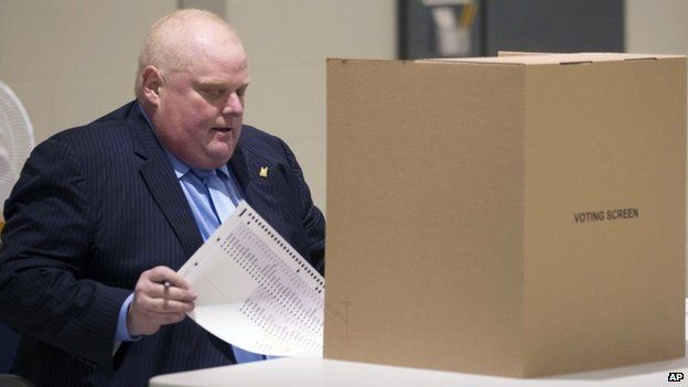 Toronto Mayor Rob Ford sits to down to cast his ballot in advance voting for the Toronto Municipal Election at a polling station in the Etobicoke area of Toronto 14 October 2014
