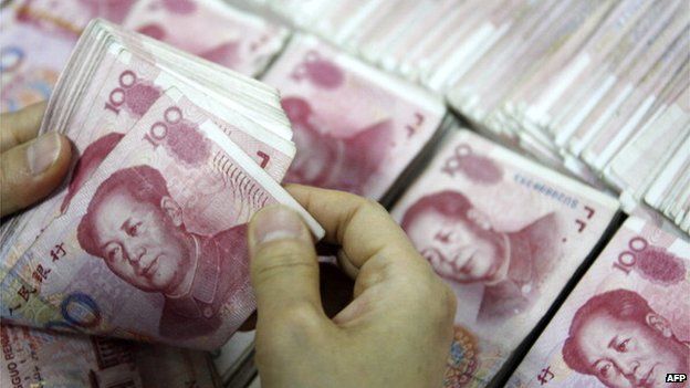 This picture taken on 24 September 2013 shows Chinese 100 yuan (RMB) bank notes being counted at a bank in Huaibei, in eastern China's Anhui province