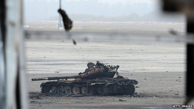 Knocked-out tanks litter the runway