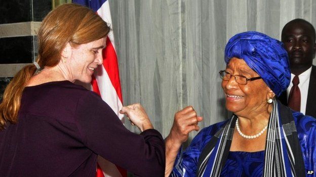 Ellen Johnson Sirleaf (right) gives US Ambassador to the UN Samantha Power what is know as the Ebola hand shake during a news conference in Monrovia, Liberia (28 October 2014)