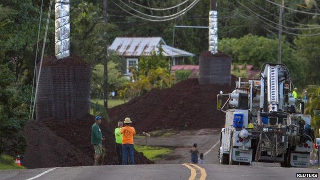 Construction crews prepare Pahoa Village Road as lava flow from Mt Kilauea approaches the village of Pahoa (28 October 2014)