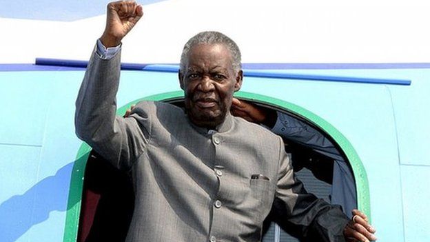 Michael Sata gestures upon arrival at Solwezi airport before addressing supporters at an election campaign meeting in September