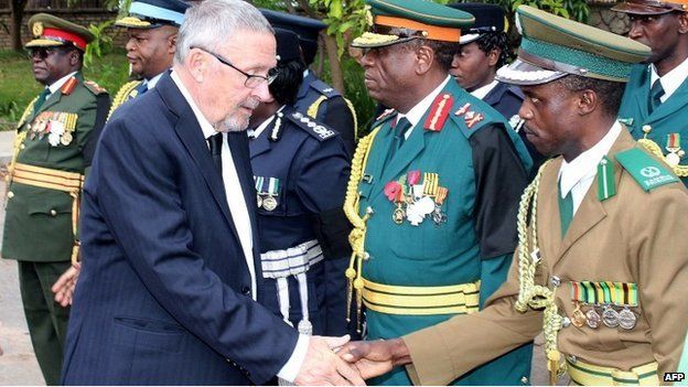Zambia's Vice-President Guy Scott (L) greets defence and security chiefs shortly after taking over as acting president following Michael Sata's death on 29 October 2014