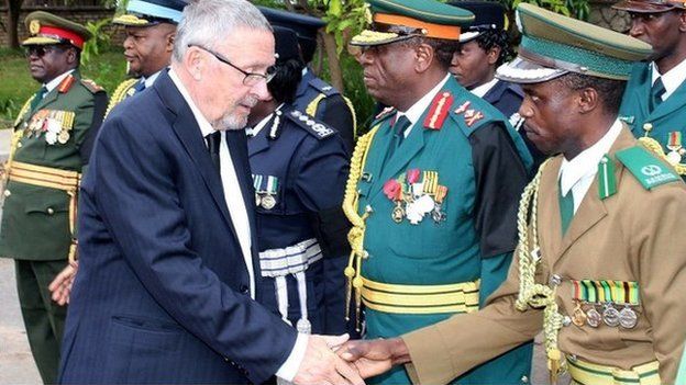 Zambia's Vice-President Guy Scott (L) greets defence and security chiefs shortly after taking over as acting president following Michael Sata's death on 29 October 2014