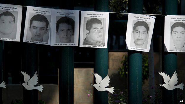 Images of the missing 43 rural college students hang on the front gate of the Mexican attorney general's office in Mexico City, Wednesday, Oct. 29, 2014.
