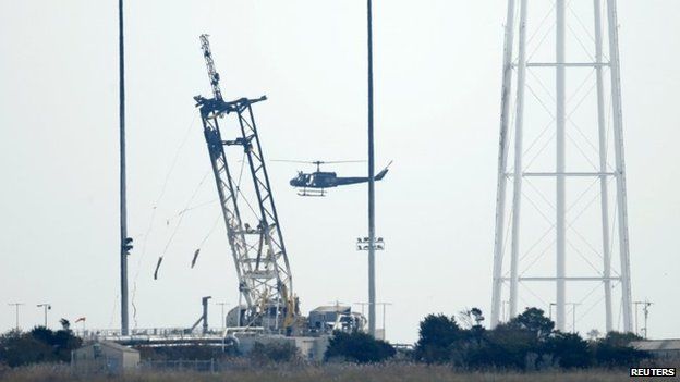 A helicopter does reconnaissance over the launch pad at NASA Wallops Flight Facility in Virginia on 29 October 2014