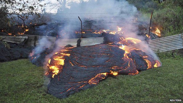 The lava flow from the Kilauea Volcano burned vegetation as it approaches a property boundary in Pahoa, Hawaii, on 28 October