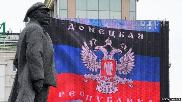 The "Donetsk People's Republic" flag is displayed on a screen in Lenin Square, Donetsk