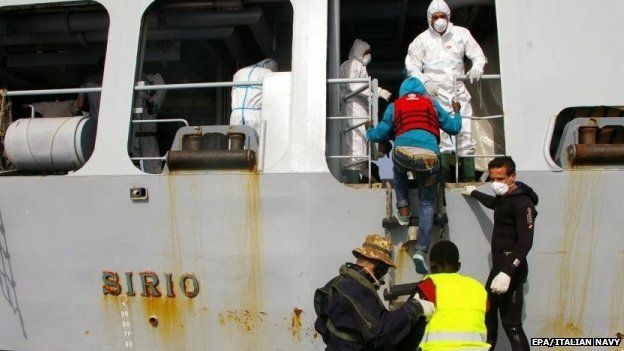 Migrants helped aboard an Italian Navy ship