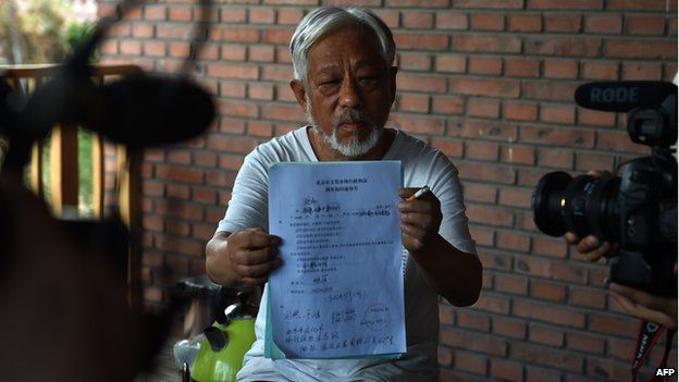 Beijing Independent Film Festival organiser Li Xianting displays a document issued by police following his release