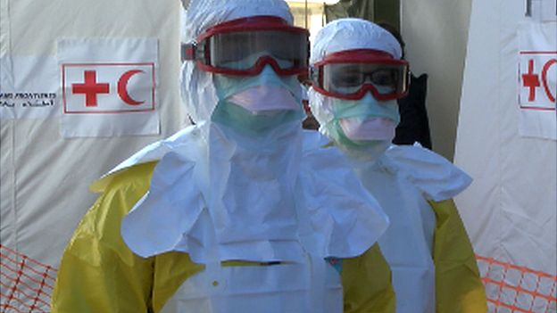 Red Cross volunteers in their full protective gear