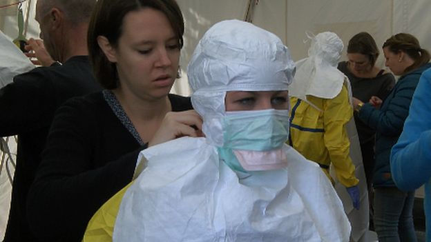 A volunteer has her mouth protected, a vital protection against Ebola