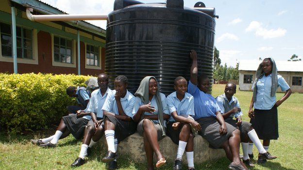 Schoolgirls sit around a water tank in Laikipia county in northern Kenya