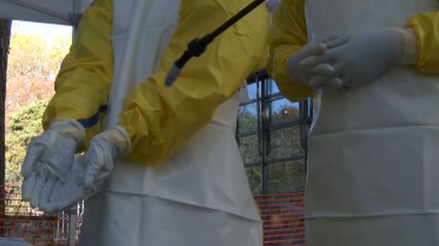 Cleaning medical gloves at an Ebola training course