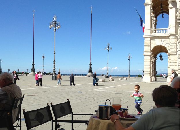 A child plays near the seafront in Trieste