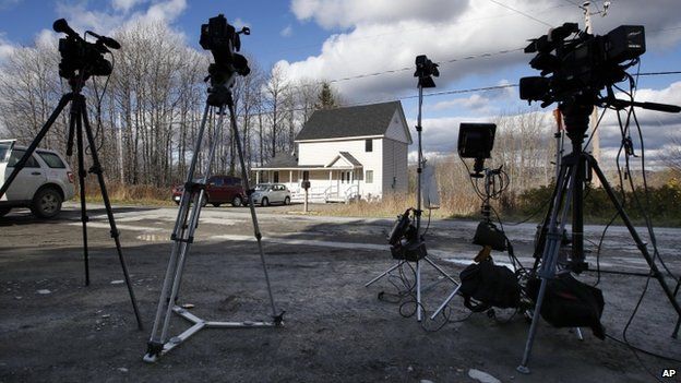 Television cameras stand on the road across from the house of nurse Kaci Hickox in Fort Kent, Maine 30 October 2014