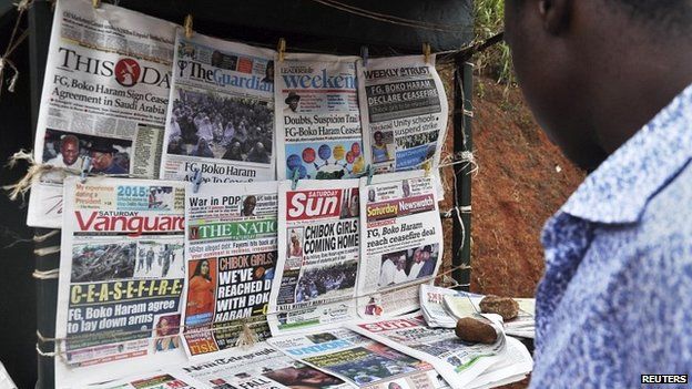 Newspapers with headlines on the Chibok girls and their possible release are displayed at a news stand in Abuja - 18 October 2014