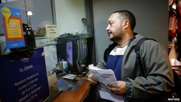 A man waits to register as a marijuana home grower at a postal office in Montevideo August 27, 2014