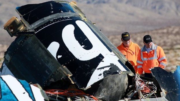 Sheriff's deputies inspect the wreckage of the Virgin Galactic SpaceShip 2 in a desert field November 2, 2014 north of Mojave, California