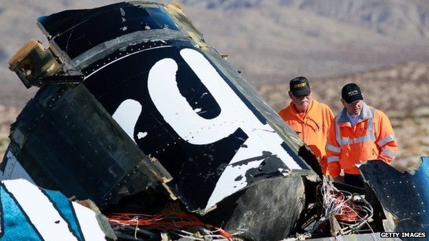 Sheriff's deputies inspect the wreckage of the Virgin Galactic SpaceShip 2 in a desert field November 2, 2014 north of Mojave, California