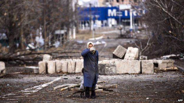 An elderly woman pulls a cart with firewood near the Donetsk airport. Photo: 3 November 2014