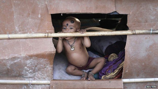 A child - whose parents say they belong to the Rohingya community from Burma - at a makeshift shelter in Delhi, India. Photo: September 2014