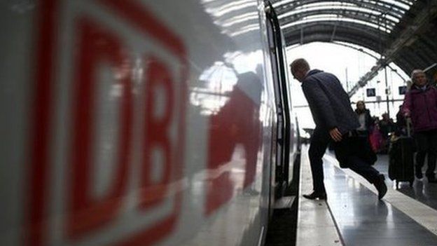 Passenger stepping onto Deutsche Bahn train