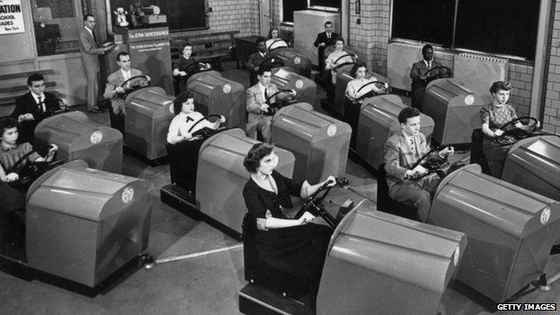 1953 image of people learning to drive in simulators