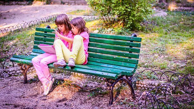 Children reading in park