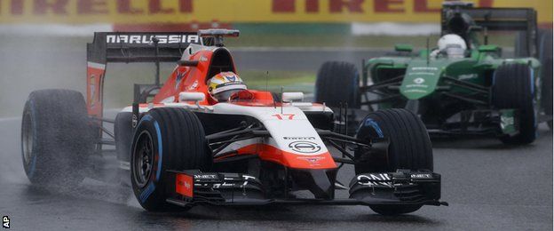 Marussia driver Jules Bianchi of France leads Caterham driver Kamui Kobayashi of Japan during the Japanese Formula One Grand Prix.