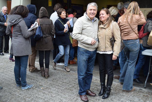 Husband and wife Cesar Saiz Lilian Subietas after voting at the CIC high school polling station in Barcelona, 9 November