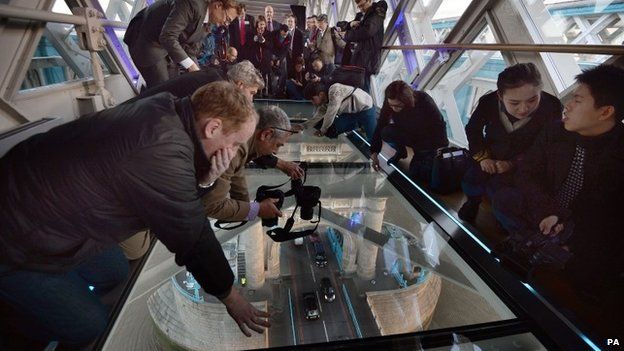 Visitors try out the new glass walkway at Tower Bridge