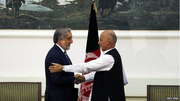 Afghan rival presidential candidates Abdullah Abdullah and Ashraf Ghani shake hands after exchanging signed agreements for the country's unity government in Kabul on 21 September 2014.