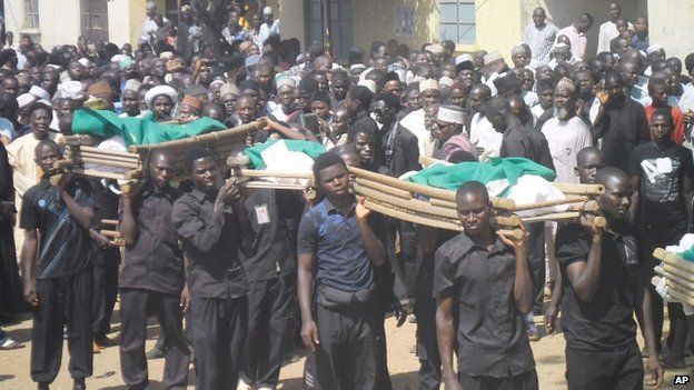 Bodies of the victims of a suicide bomb explosion are carried for burial in Potiskum, Nigeria on 4 November 2014