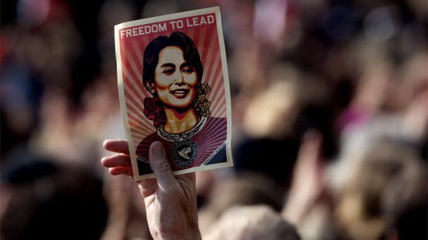 A man holds on 16 June, 2012 a poster of Myanmar opposition leader Aung San Suu Kyi during a public meeting following a ceremony where Suu Kyi formally accepted her Nobel Peace Prize in Oslo