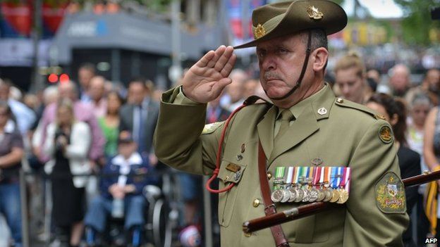 Australian Army Warrant Officer Stephen Chiesa observes a minute's silence at the Cenotaph national war memorial to pay tribute to the Commonwealth war dead on Armistice Day in Sydney on 11 November 2014