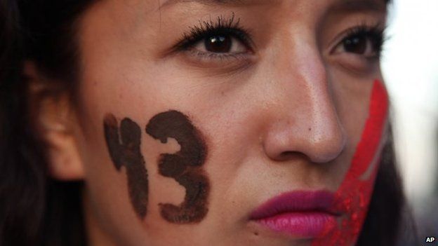 A female demonstrator in Mexico City with the number 43 painted on her face marches in protest for the disappearance of 43 students on 5 November 2014