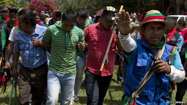 Members of the Nasa indigenous guard escort Farc rebels accused of murdering two Nasa leaders on 9 November, 2014, in Toribio