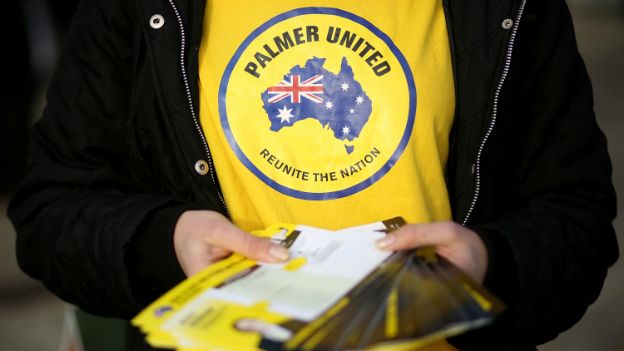 A Palmer United Party promoter hands out election flyers at a polling station in Melbourne - 7 September 2013