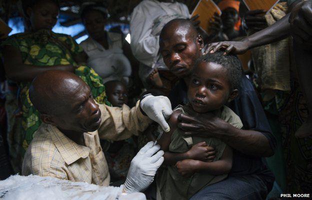A child is given a measles vaccination