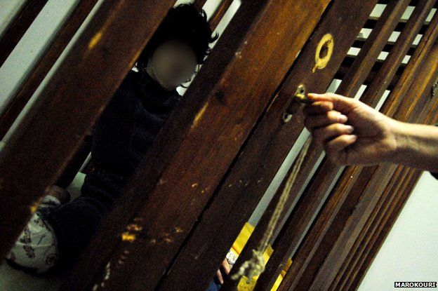 A child in a cage, photographed at the centre in 2008