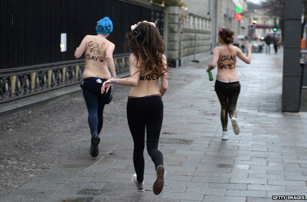 Three topless Femen activists demonstrate in front of the Russian Embassy in Berlin on February 7, 2014