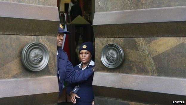 Police officers closing parliament's doors in Cape Town, South Africa in August 2014