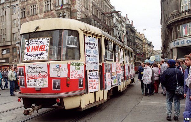 Young Czechoslovak people surround a tramway covered with posters in support of Vaclav Havel