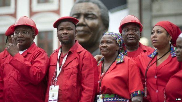 Members of the Economic Freedom Fighters(EFF) pose for a photo in front a bust of Nelson Mandela at the South African parliament, Cape Town, South Africa - May 2014