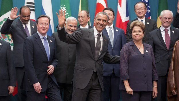 US President Barack Obama, centre, and Brazilian President Dilma Rousseff, right, walk off stage with other world leaders after the G20 Summit family photo in Brisbane, Australia, on 15 November 2014