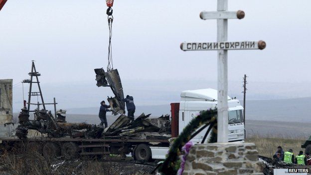 Local workers carry wreckage of the Malaysia Airlines Boeing 777 plane (flight MH17) at the site of the plane crash near the settlement of Grabove in the Donetsk region, Ukraine, 16 November 2014