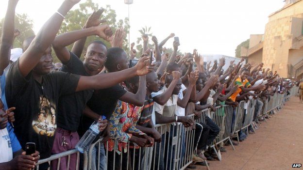 People cheer Lt Col Isaac Zida during the signing of a transition charter in Ouagadougou on 16 November 2014