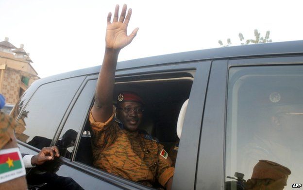 Burkina Faso's army-appointed leader, Lt Col Isaac Zida waves after the signature of a transition charter at the Masion du Peuple in Ouagadogou on 16 November 2014.